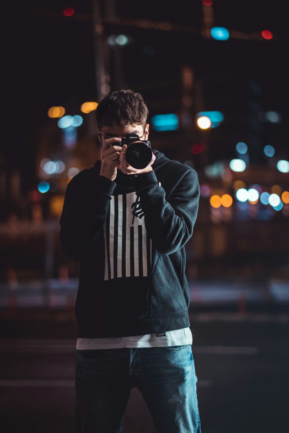 standing man holding camera