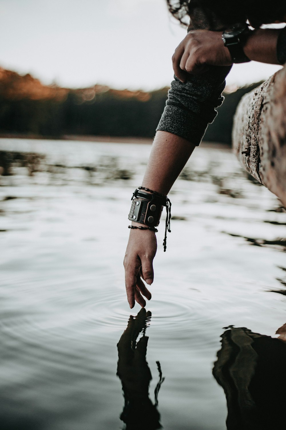 person fingers on water