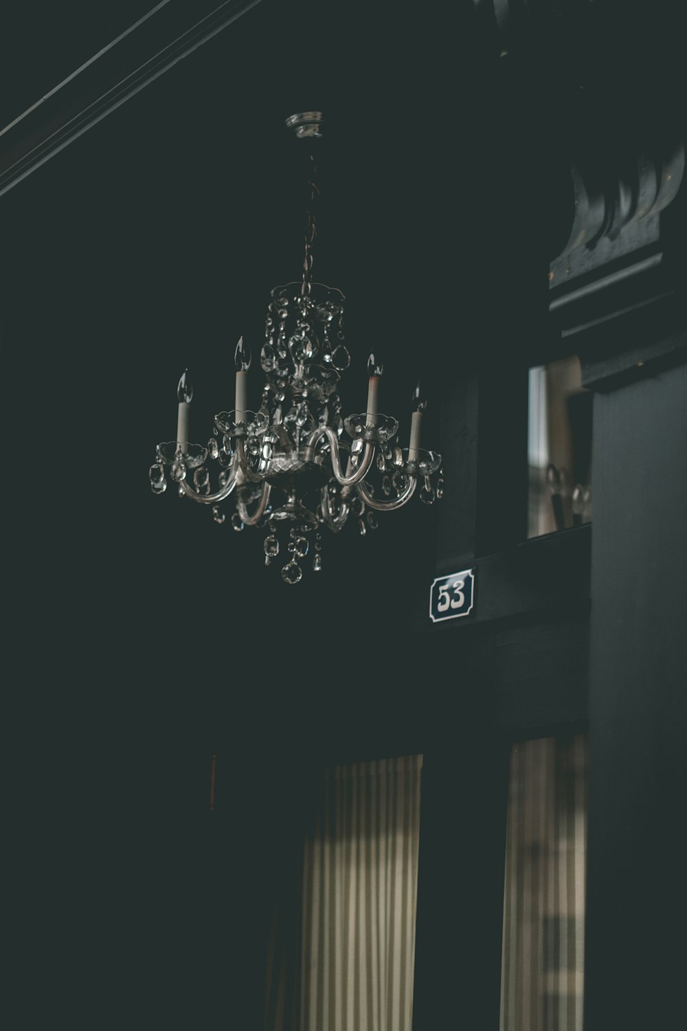 a chandelier hanging from the ceiling in a dark room