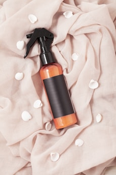 Sleek aromatic spray misting softly against a white backdrop