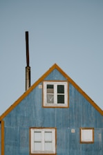 photo of blue and brown wooden house