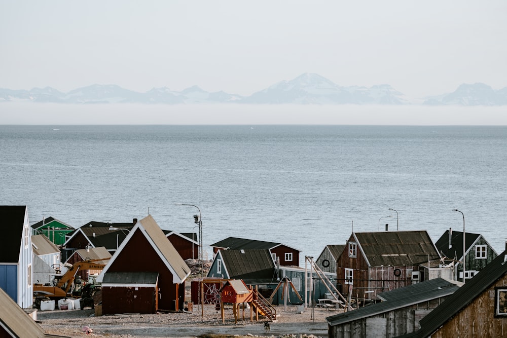 brown wooden houses near beach during daytime