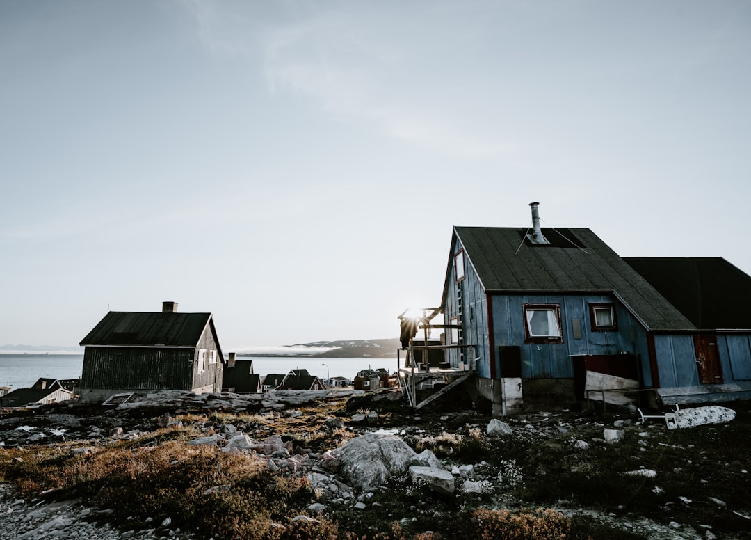 three houses near body of water