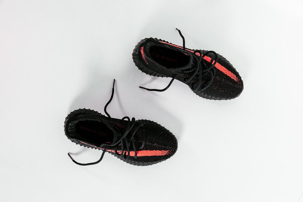 pair of bred adidas Yeezy Boost 350 v2 shoes on white surface