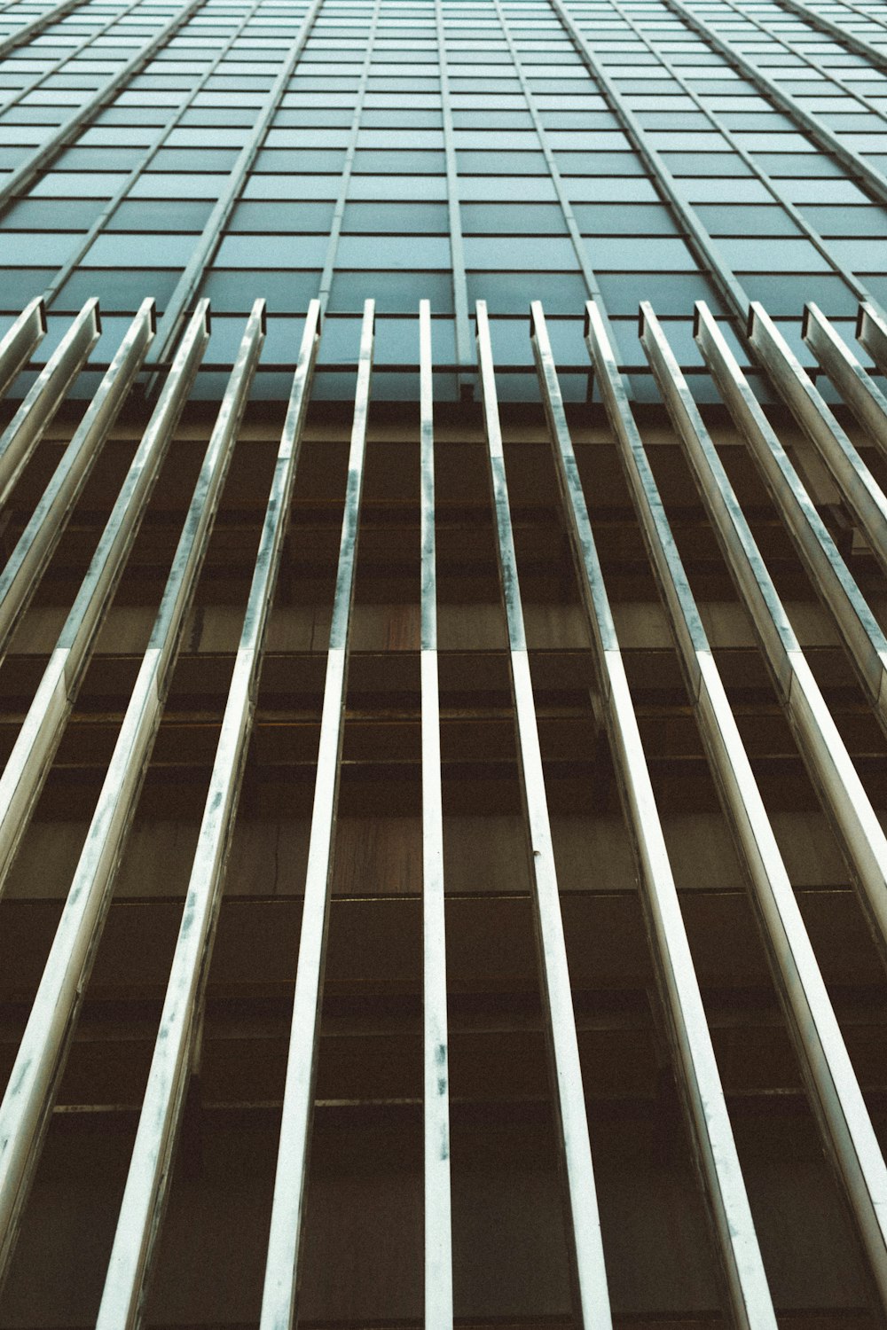 low angle photography of gray metal building