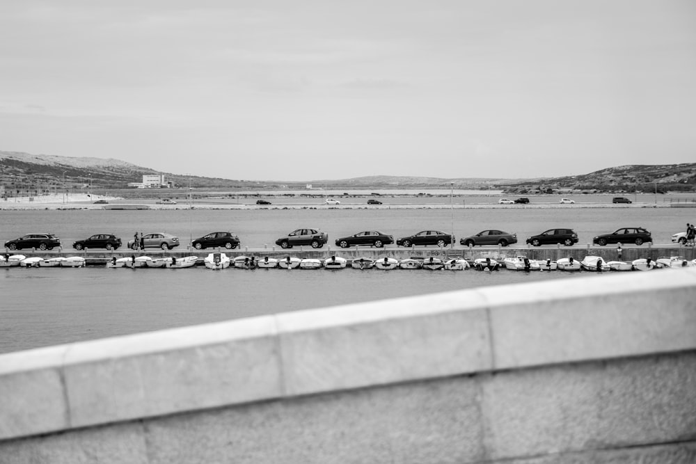 grayscale photo of body of water near city buildings