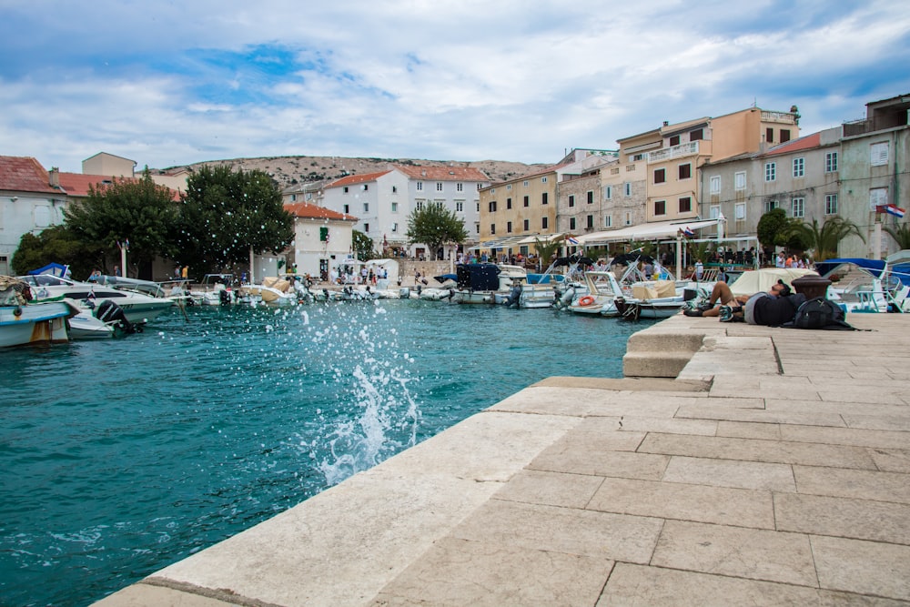 people in swimming pool near buildings during daytime