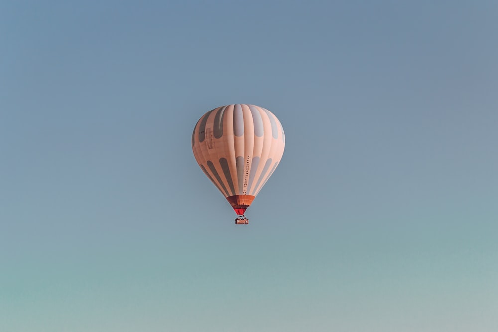 white and blue hot air balloon on sky