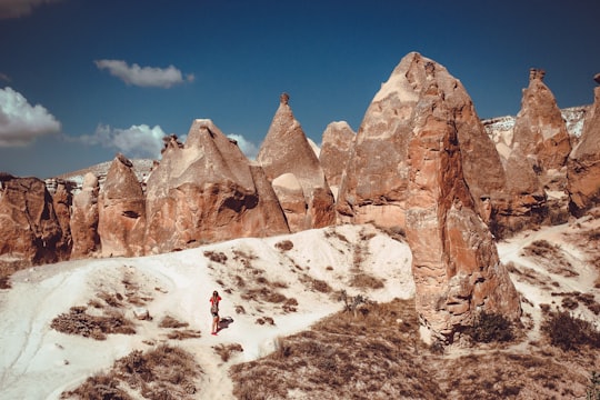 woman standing in front of huge boulders in Göreme Turkey