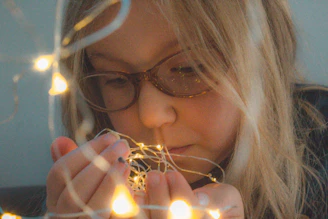 A child conducting a glowing light experiment in a bright, modern lab setting.