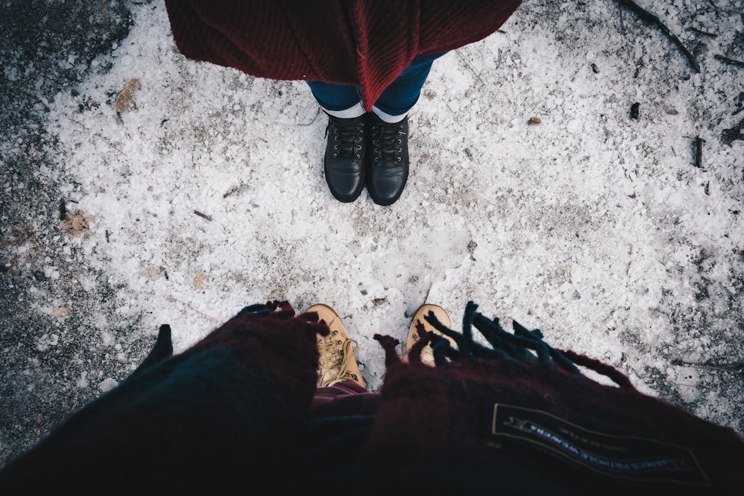 two standing person wearing shoes