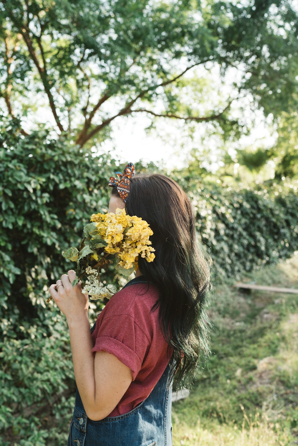 woman holding yellow flowers