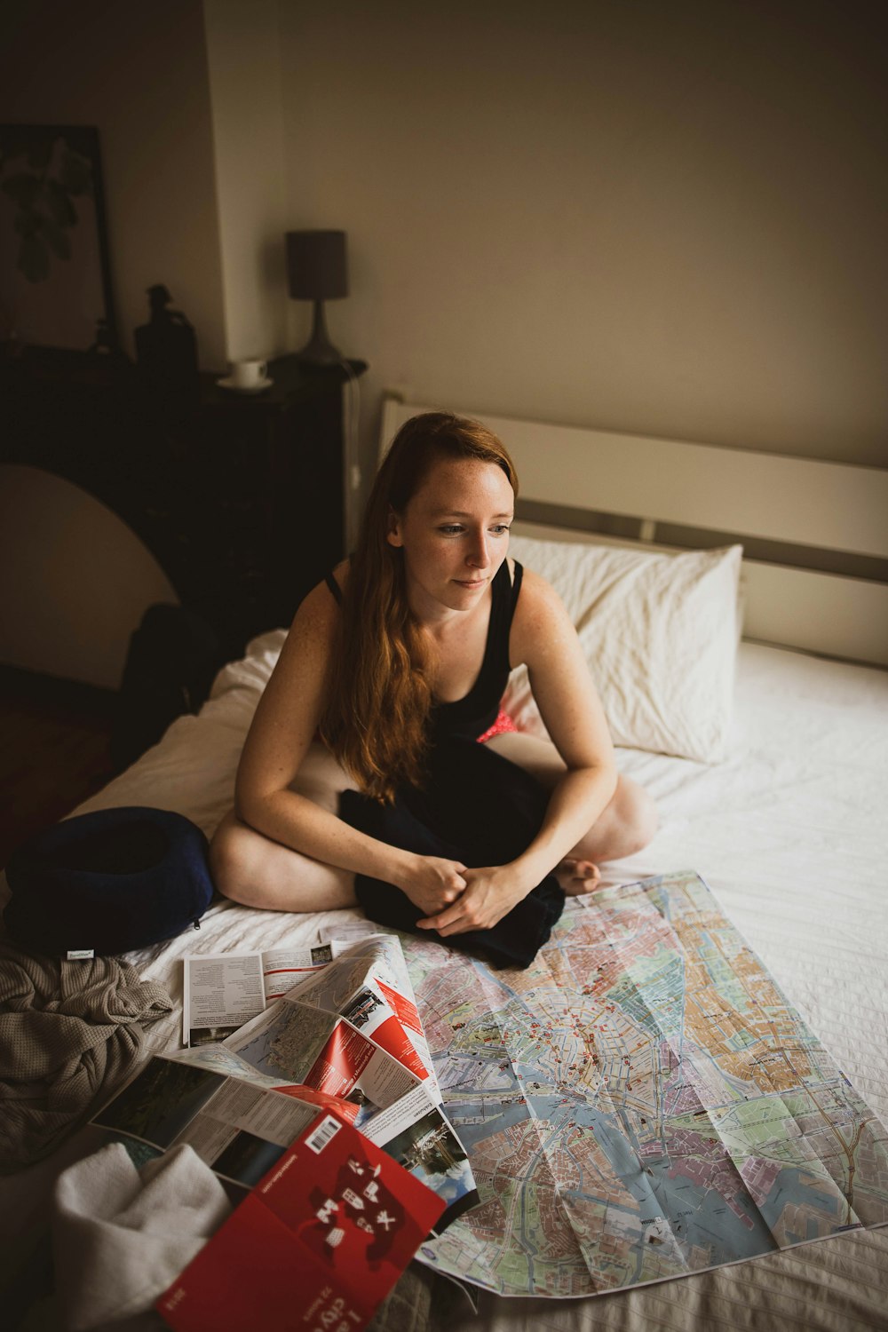 woman sitting on bed inside room