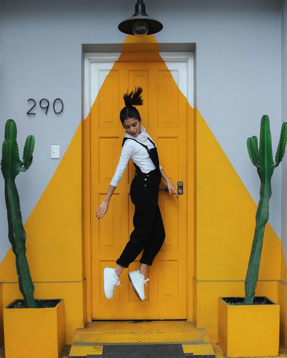 woman jumping in front of closed door