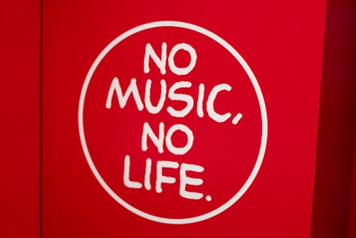 A red background features a white circle with the phrase 'NO MUSIC, NO LIFE' written in bold, white letters.