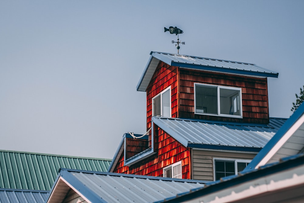 red and blue house under gray sky during daytime