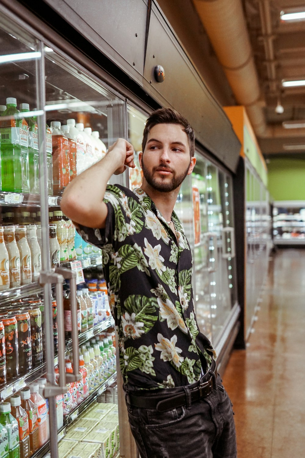 man standing beside commercial refrigerator