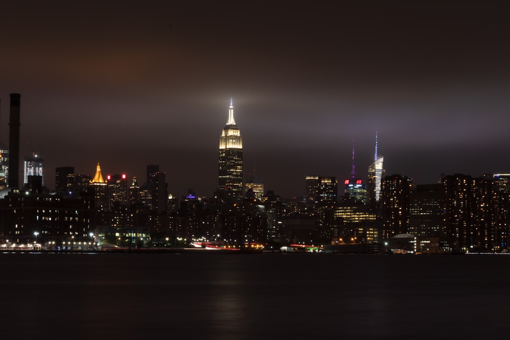 city buildings under gray sky during nighttime