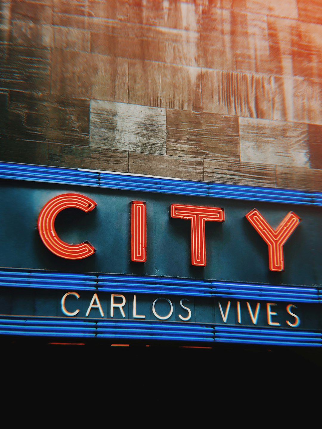 close-up photo of City Carlos Vives signage
