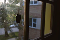 Close-up of a grimy vertical blind with dust buildup before service.