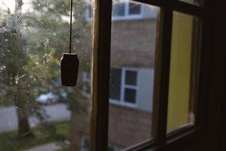 Close-up of a grimy vertical blind with dust buildup before service.