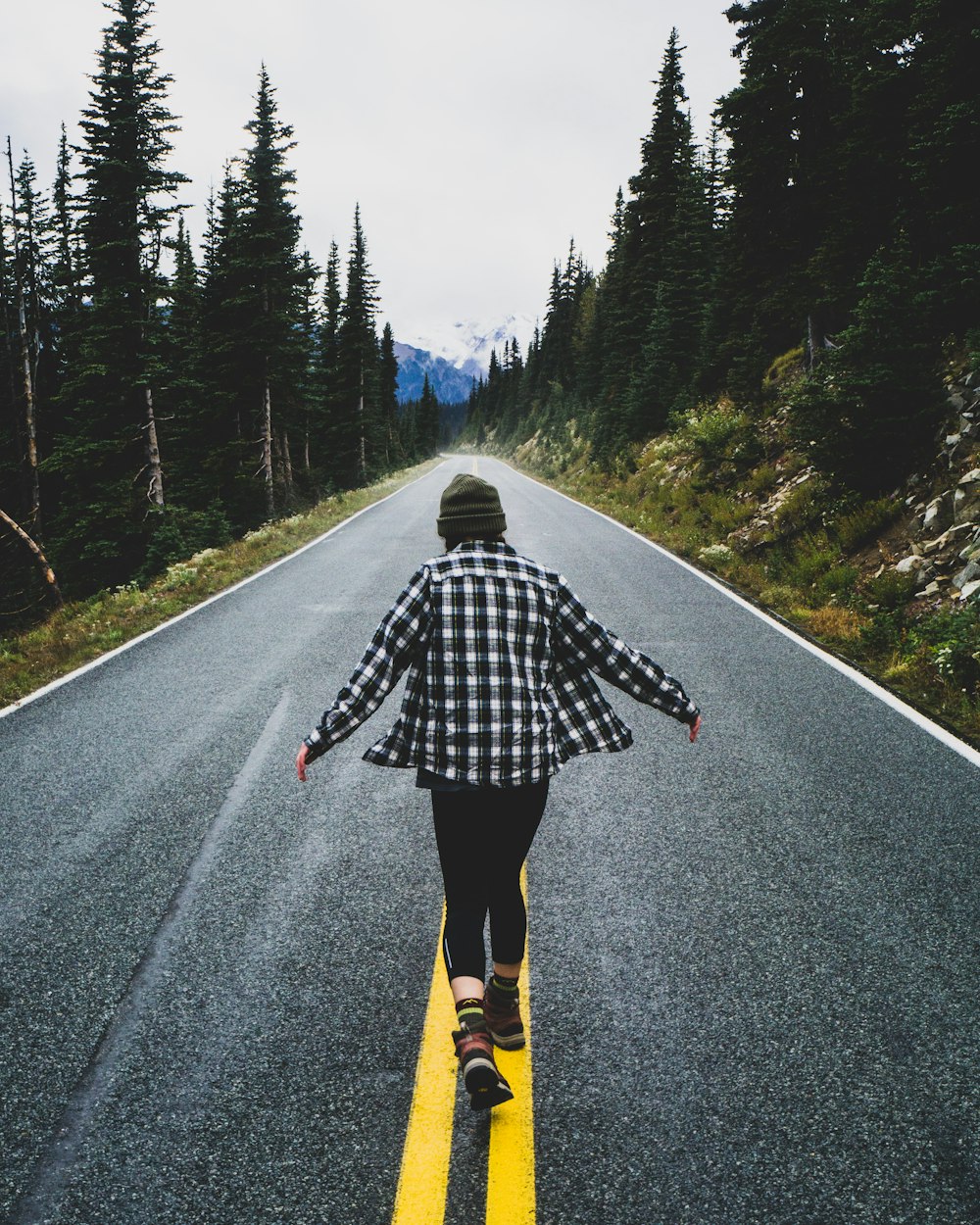 person walking on concrete road at daytime