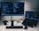 laptop computer beside monitor with keyboard and mouse