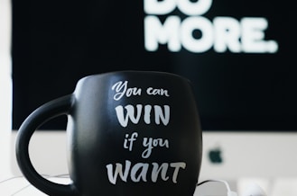 close up photography of black and white ceramic mug on table