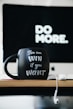 close up photography of black and white ceramic mug on table