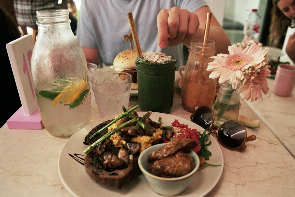 person sitting at table in front of cook food