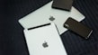 A collection of modern electronic devices, including a laptop, tablet, smartphone, and a portable external hard drive, all displaying a sleek and minimalist design with a focus on metallic and dark tones.
