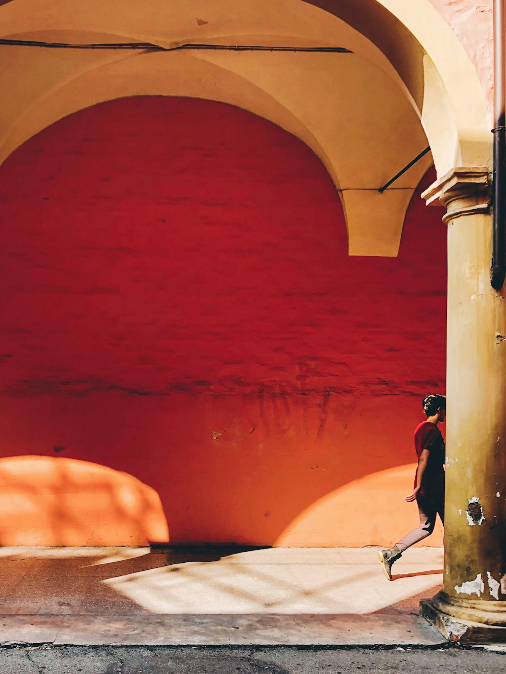 man passing by on wall