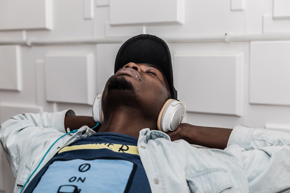 man wearing denim jacket wearing headphones and listening to music