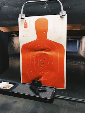 Participants practicing target shooting under supervision at a well-equipped shooting range.