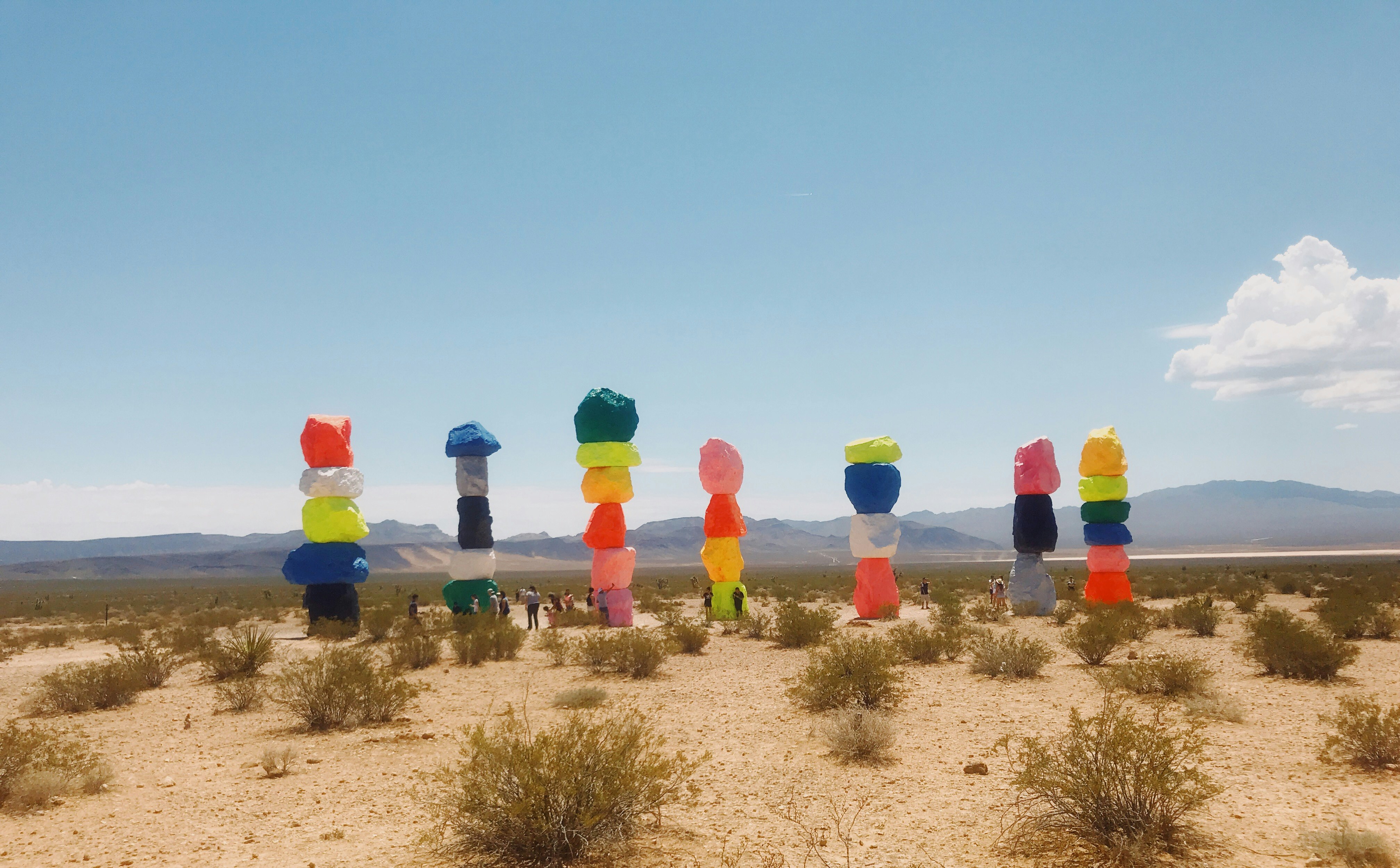 assorted-color balloon stonehenge at the desert during daytime