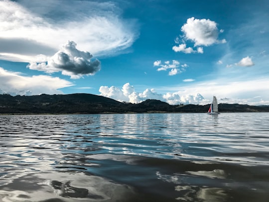 both on body of water under blue sky in Guatavita Colombia