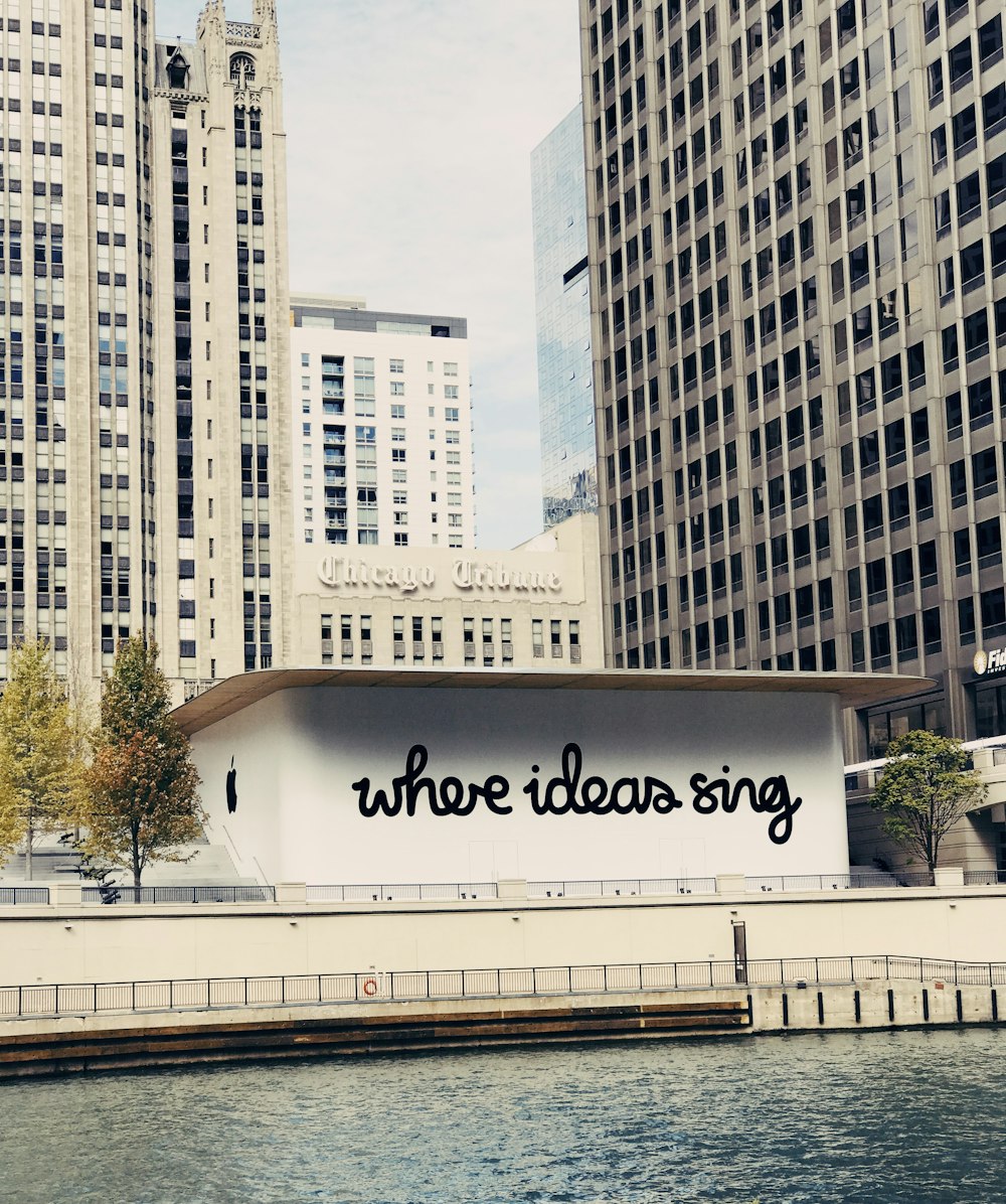 white concrete building near body of water