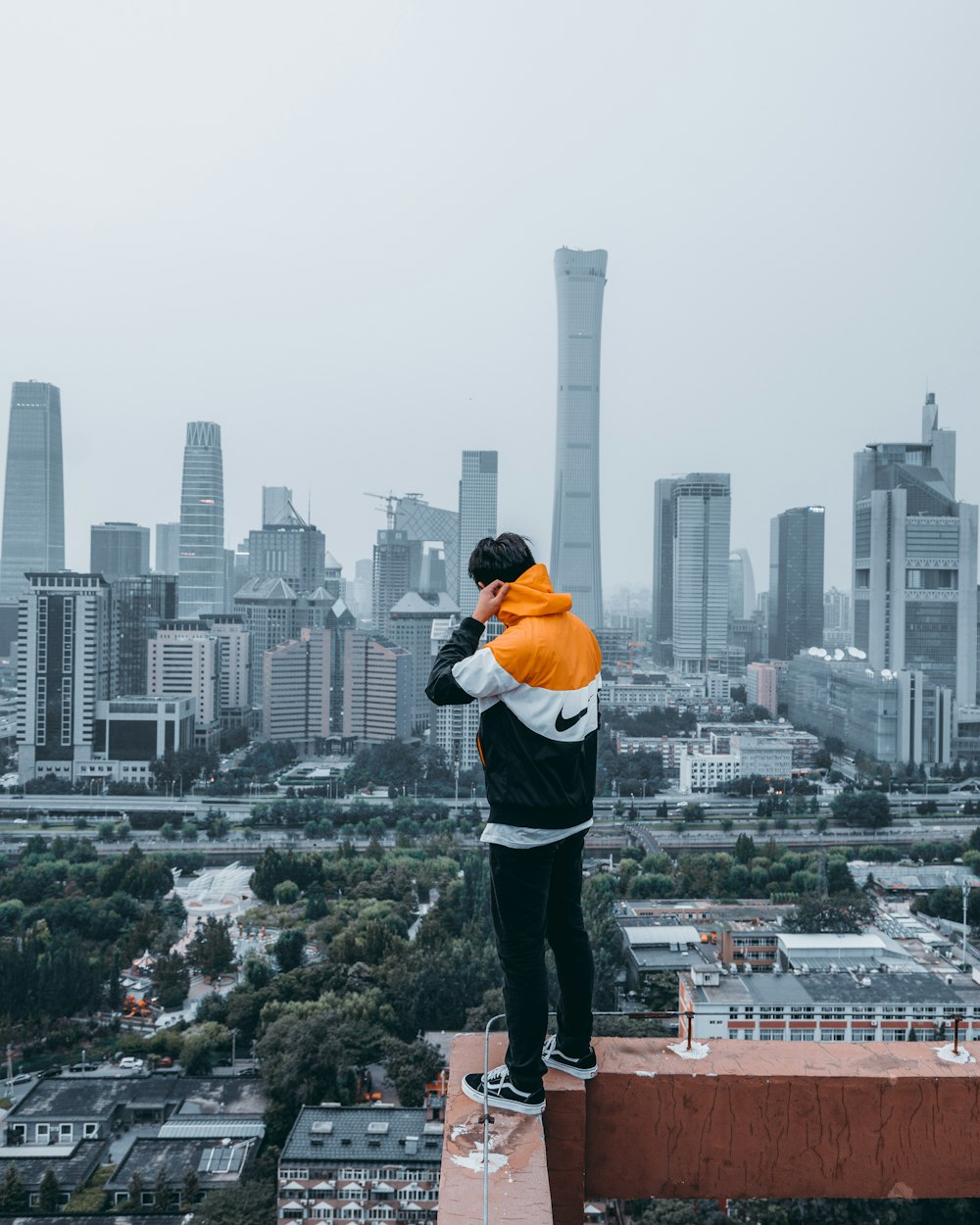 person standing on cliff wall during daytime