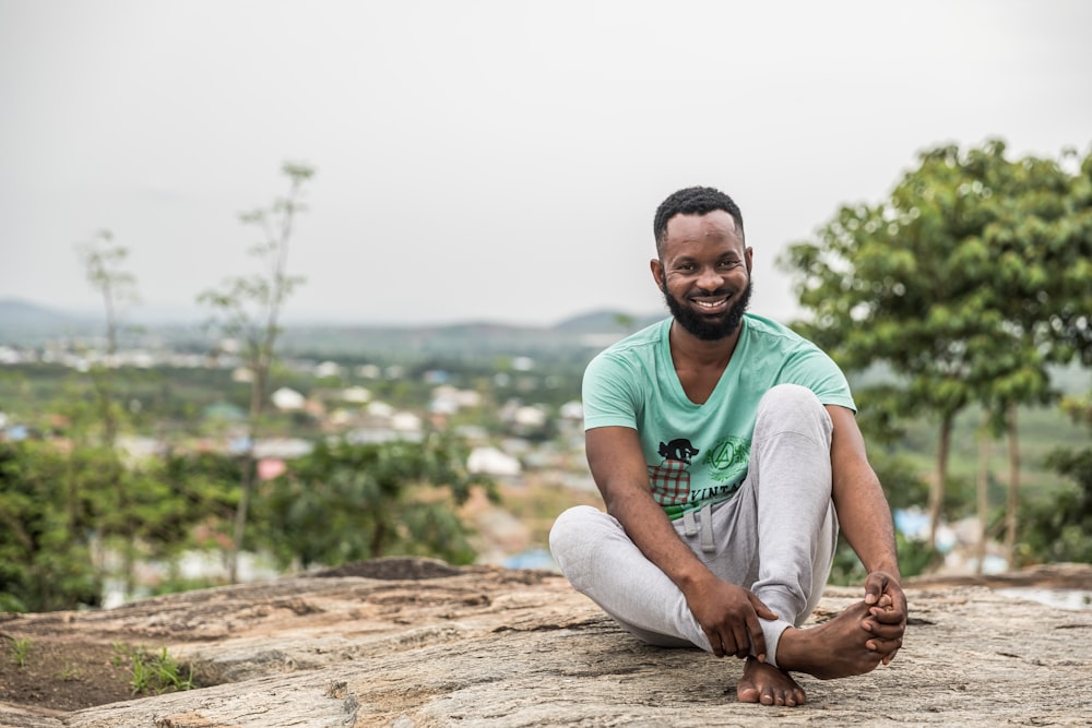 man sitting on rock