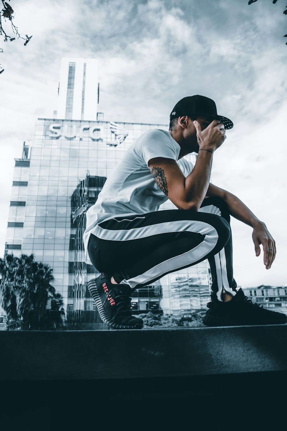 man sitting on concrete pavement