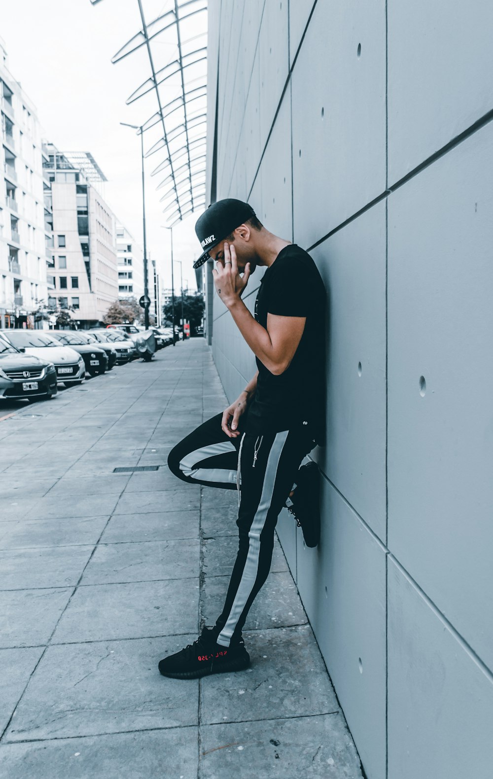 man leaning on wall