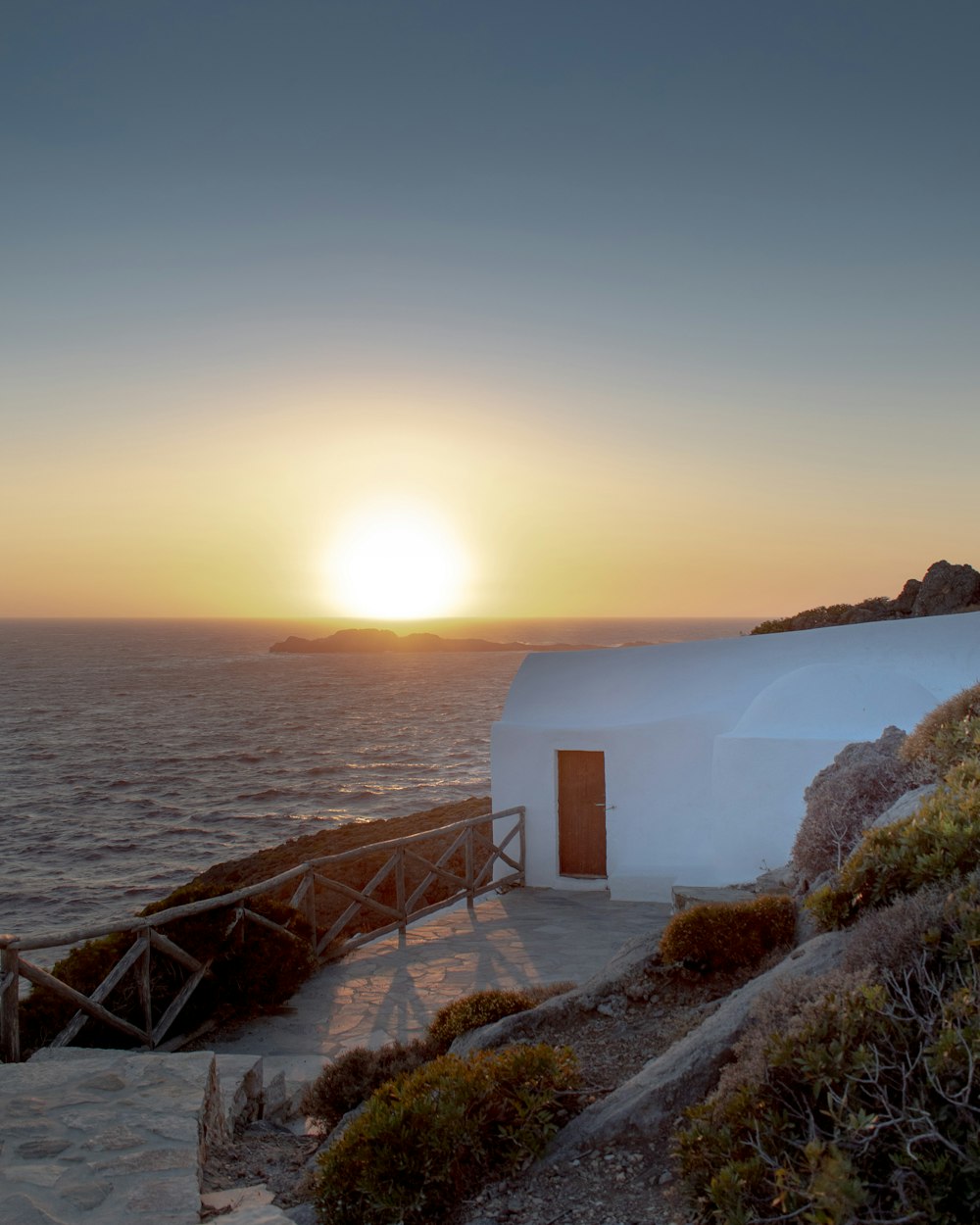 house near body of water during golden hour