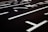 Dark asphalt road marked with white lane dividers and directional arrows, featuring clear Japanese kanji characters.