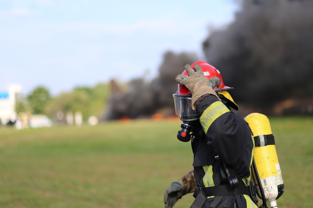 firefighter touching own helmet during day