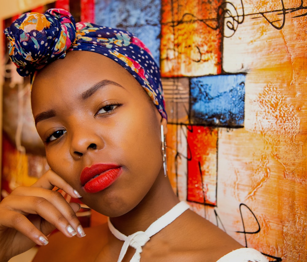 woman taking selfie front of multicolored textile