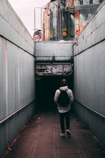 A commuter walking through a city with a sleek backpack.
