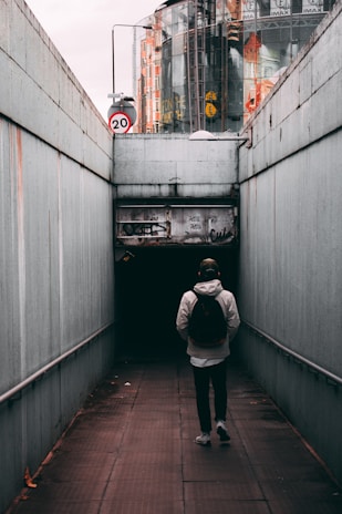 A commuter walking through a city with a sleek backpack.