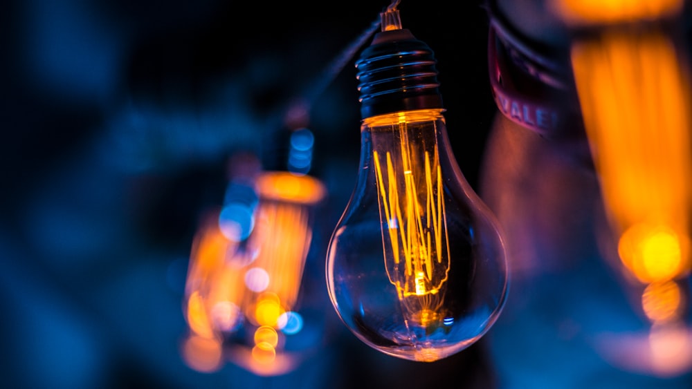 selective focus photography of clear light bulb