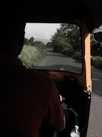 A Tirupati Transport vehicle driving on a highway with clear skies.