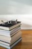 clear framed eyeglasses on top of pile of books